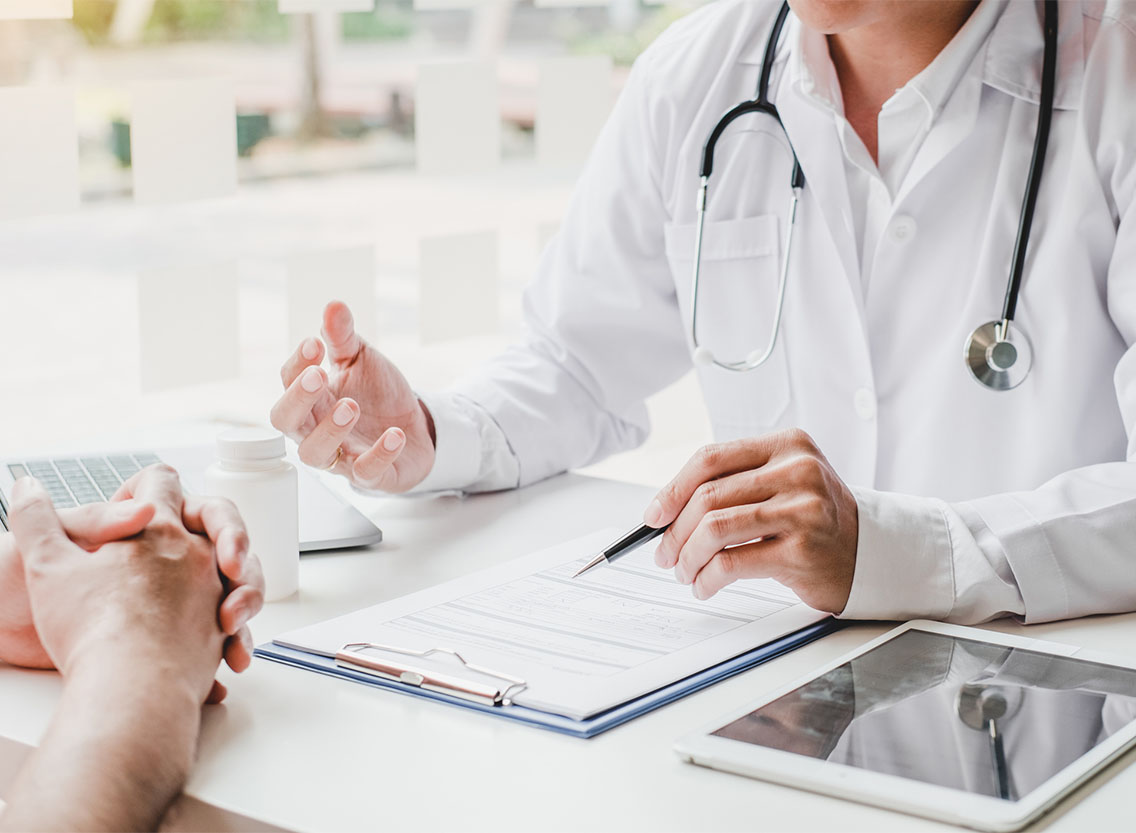 Doctors and patients consulting and diagnostic examining sit and talk. At the table near the window in the hospital medicine concept